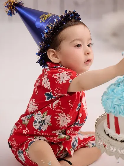 That moment of intense focus before the first taste. We capture the entire story of the cake smash, from anticipation to celebration.