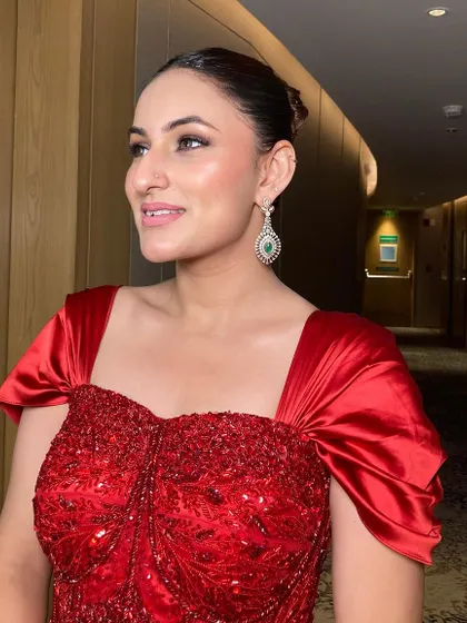 The side profile of this bridesmaid in her stunning red gown. The clean makeup and sleek hair ensure that she looks sophisticated and beautiful.