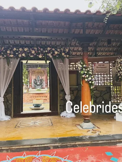 The entrance to the naming ceremony, decorated with white drapes and floral arrangements that match the lavender theme inside.
