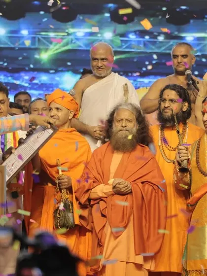 Spiritual leaders and dignitaries on stage under a shower of confetti, celebrating the successful event. We add celebratory touches like confetti blasts to mark key moments.