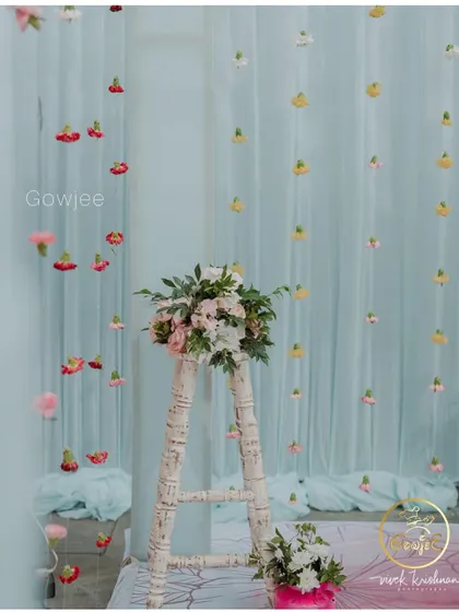 A simple yet beautiful decor element featuring a white ladder adorned with a floral arrangement.