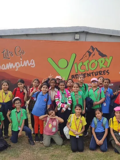 "Every child has a right to adventure." Our students stand before the banner at Victory Adventures, embodying the spirit of exploration and fun that we encourage.