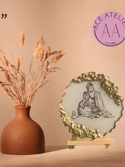 A 5-inch Guru Nanak Dev Ji frame, perfect for placing on a desk or in a small nook. The simple line art and gold accents create a peaceful and elegant look.