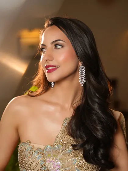 A smiling portrait of the model, her diamond earrings adding a touch of sparkle.