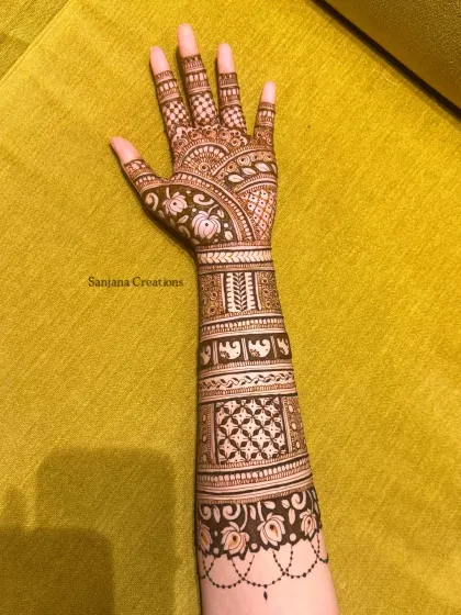 A side view of the Ganesh Chaturthi mehndi, showing the intricate details on the arm.