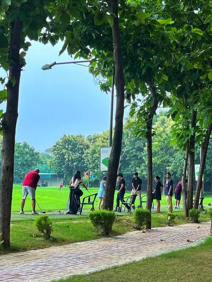 The view from the paved pathway, showing golfers spread out along the tree lined range. It's a perfect escape from the city.