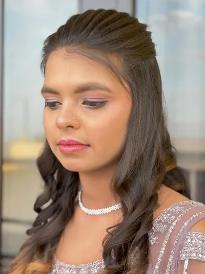 Another angle of the soft curls and makeup, highlighting the flawless base and blended eyeshadow.
