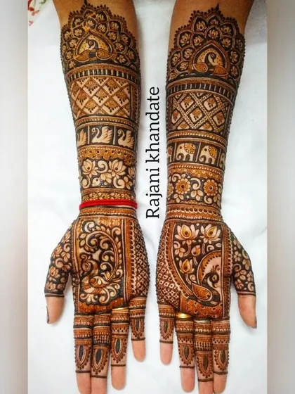 A perfect bridal design with full-arm coverage. This intricate work features peacocks, elephants, swans, and a variety of floral and geometric bands, creating a rich and regal look.