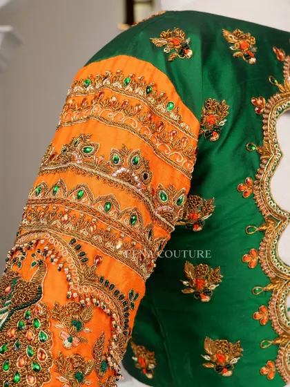 This blouse is a celebration of vibrant color and artistry. I used a rich green raw silk base and contrasted it with bright orange sleeves, which feature incredibly detailed peacock embroidery using zardozi, stones, and beadwork.