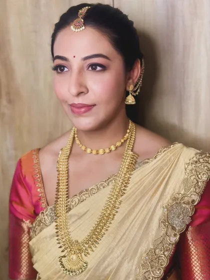 A gorgeous, minimalist Muhurtham look for Gouthami, featuring soft pink tones on the eyes and lips.