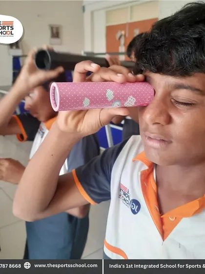 A close-up of a student's fascination with light and optics during our hands-on science session.