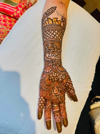 A single-hand view of a personalized bridal design. You can see the custom elements like the year and symbols clearly.