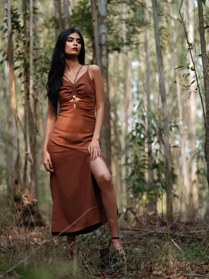 A different take from the forest shoot, this pose is more direct and confident, showcasing the model's presence and the beautiful texture of her dress.