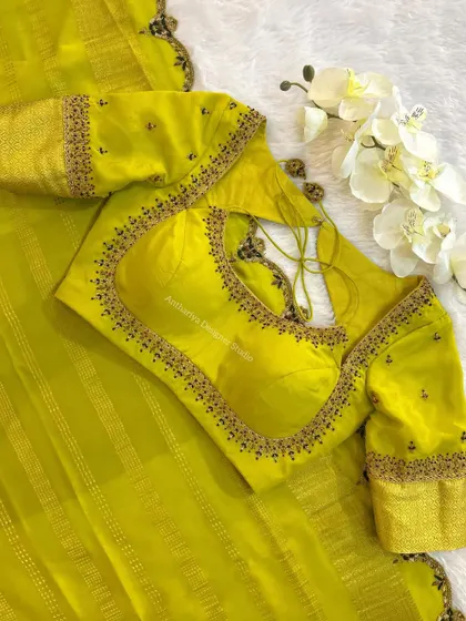 A vibrant lime green blouse with a simple embroidered border and a stylish back cutout.