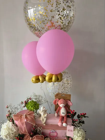 A view showing the pink and gold confetti balloons with the floral hamper.