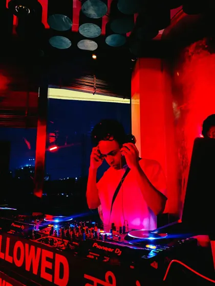 Putting on the headphones to cue up the next track. Concentration is key to maintaining the flow of the night.