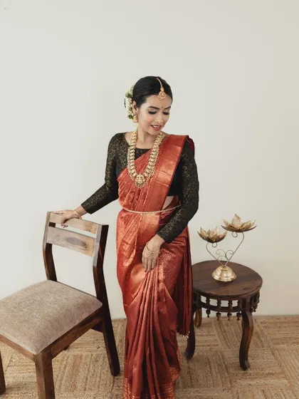 This portrait demonstrates a classic South Indian look with a clean bun, jasmine flowers, and timeless makeup. It's a staple look that every aspiring bridal MUA needs to master.