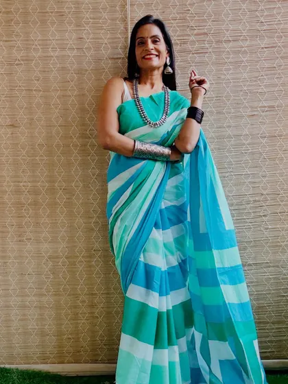 The cool shades of blue and green in this striped cotton mulmul saree are very soothing. It's a perfect saree for a hot summer day.