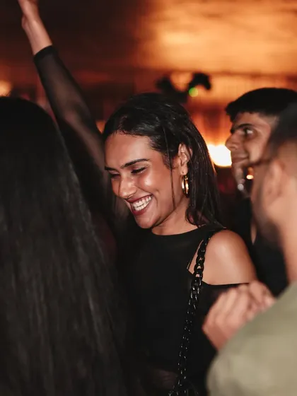 A huge smile from a guest on the dance floor, capturing the pure fun of a Saturday night at Kaze.