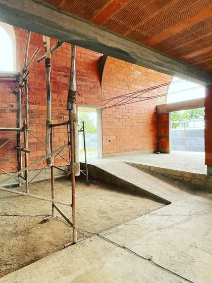 The interplay of ramps and steps within the brick-vaulted house. The design creates a dynamic journey through spaces that are defined by light and material.