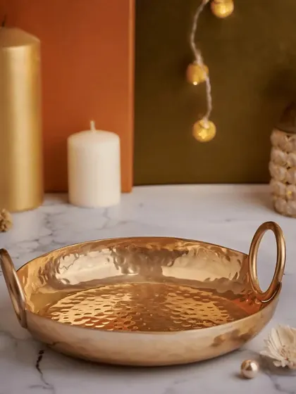A simple yet elegant hammered brass urli bowl. This versatile piece can be used as a decorative item or for floating flowers, making it a thoughtful and culturally relevant wedding favor.