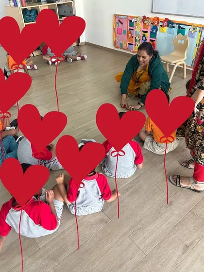 A classroom of young children lying on the floor for a group activity. Incorporating movement and different postures is important for keeping little learners engaged.
