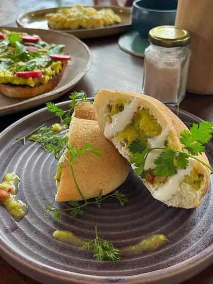 A delicious shot of guacamole with poie bread from Bloom & Brew, Goa. This image captures a unique and scrumptious dish, perfect for a cafe's social media.