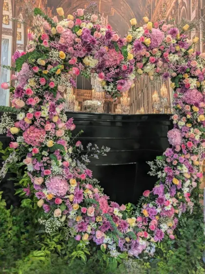 Flowers can celebrate love at any age. I designed this magnificent heart-shaped floral arch for a 60th birthday party, using a romantic palette of pinks and purples to create a stunning photo backdrop and a symbol of joy.