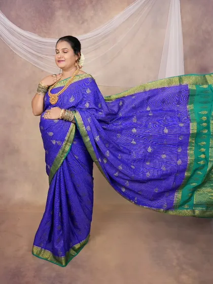 The flowing fabric of this blue saree creates a beautiful sense of motion. This is a great way to add a dynamic element to a solo traditional portrait.