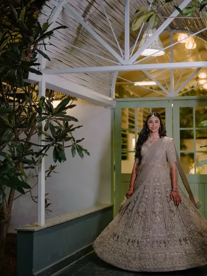 A full-length shot of the bride in her gorgeous embellished lehenga. The makeup is elegant and timeless.