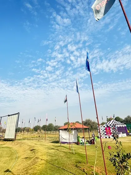 A view of our grounds set up for a tournament. The flags, tents, and sight screens create a professional match-day atmosphere, which we believe is crucial for preparing players for competitive cricket.