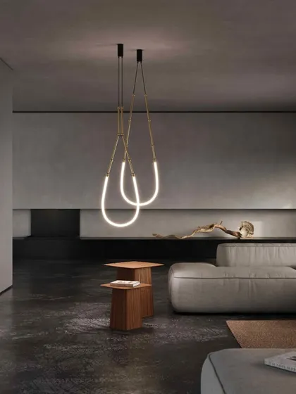 The Leda system in a minimalist setting, configured as two simple, glowing loops. The brass hardware adds a touch of warmth and luxury to the design.