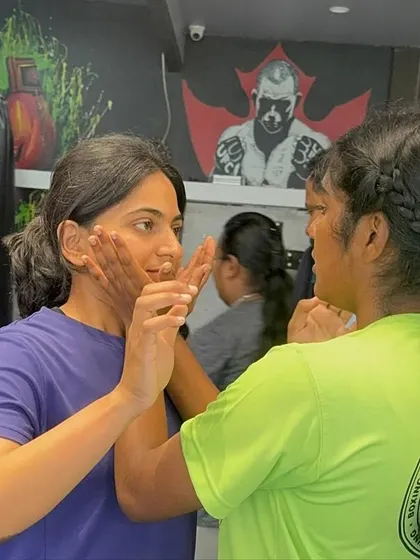 A close-up of participants practicing defensive frames to protect against strikes. This technique helps create space and shield vulnerable areas, and we drill it until it becomes second nature.