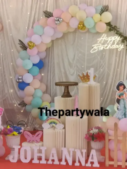A pastel-colored princess theme with a beautiful balloon arch and cutouts of Aurora and Jasmine.