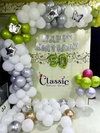 Another option for a 50th birthday at home, this version uses a touch of lime green with white and silver balloons.
