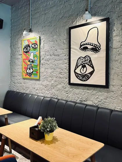 I wanted the cafe to have its own unique personality. The space is decorated with quirky, modern art and offers comfortable booth seating, making it a cool and inviting spot for a meal or coffee.