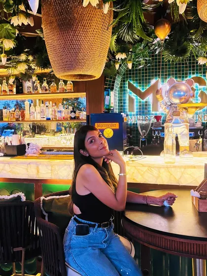 A classic brunch date outfit: a simple black cutout top paired with relaxed-fit blue jeans. It's a timeless combination that always looks cool and put-together.
