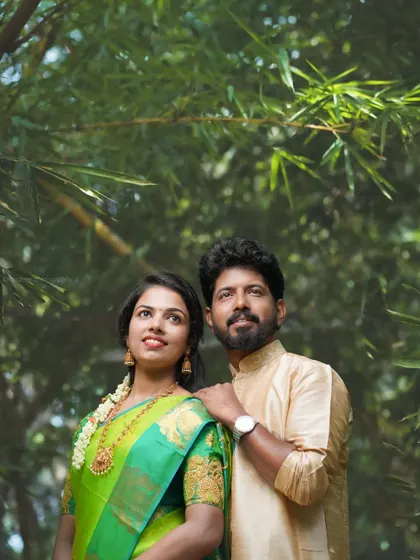 A lovely portrait from a pre-wedding series, with the couple looking up, framed by lush bamboo. This shot highlights their connection and the beauty of the natural surroundings.