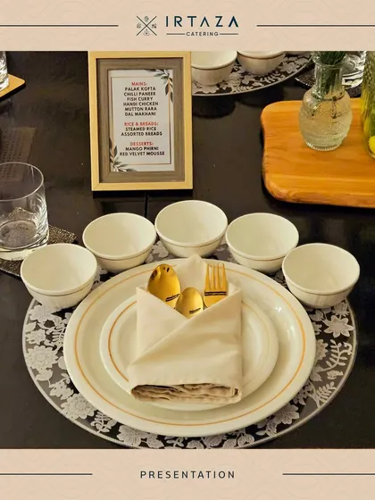 An elegant place setting for a sit-down dinner. It features a framed menu, gold-rimmed plates, and folded napkins with golden cutlery, showcasing my attention to detail for formal dining experiences.