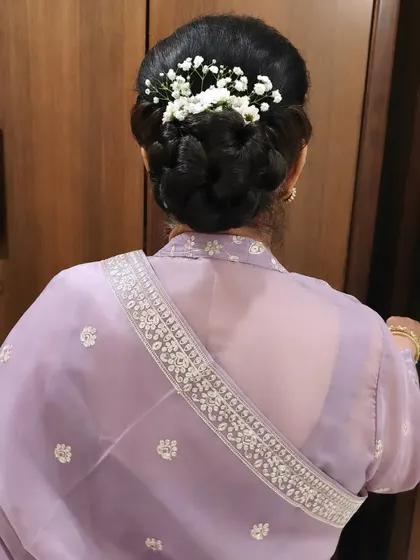 Another angle of the beautiful braided bun, showing the detail and craftsmanship that goes into creating such a polished and secure updo.