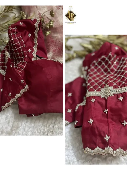 A deep maroon blouse with delicate silver thread work in a jaal pattern on the sleeves. A simple band of embroidery at the waist adds a touch of definition.