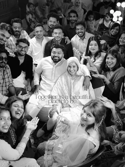 A beautiful black and white photo capturing the couple surrounded by their loved ones, all sharing in the happiness of the moment.
