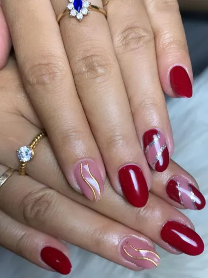 An abstract design in shades of red and pink, with gold and silver metallic accents.