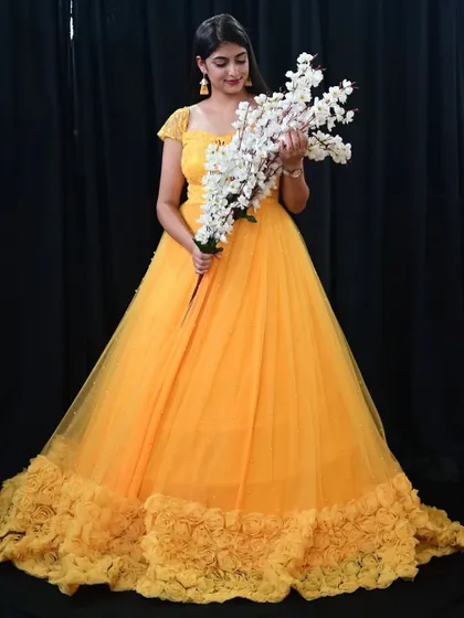 Our yellow gown with a rose-patterned trail is a beautiful and romantic option for your photoshoot.