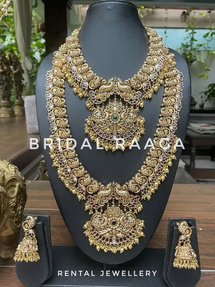 A majestic peacock-themed bridal set in a dark antique finish. The detailed craftsmanship and Kemp stone work make this a truly unique piece.