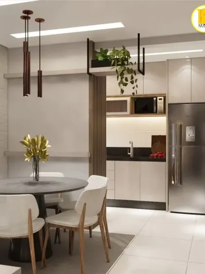 A compact dining area next to an open kitchen. The hanging planter above the partition adds a touch of green and separates the spaces visually.
