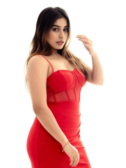 Another angle of the red dress, showing a confident and direct pose. The simplicity of the shot puts all the focus on the subject and the outfit.