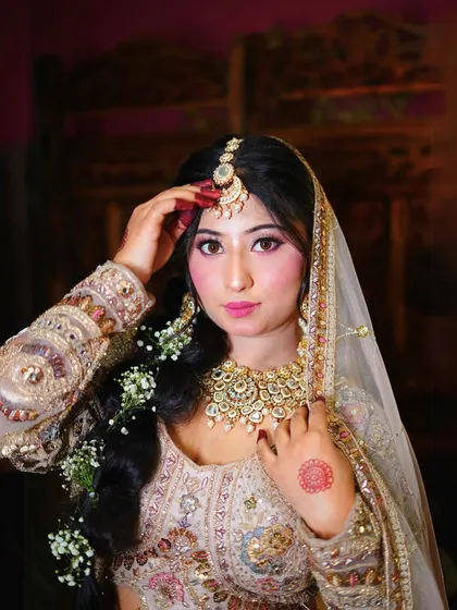 A close-up of our pastel bridal lehenga, showing the detailed embroidery and the beautiful bridal jewelry set that completes the look.