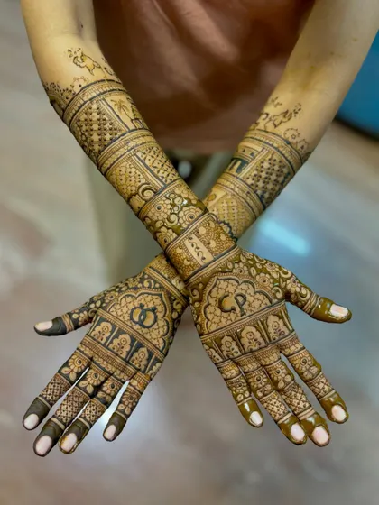 A top-down view of the engagement mehendi, highlighting the custom initials.
