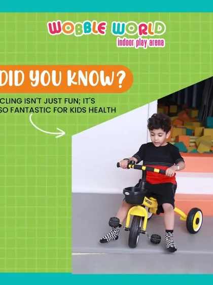 A young boy enjoying a ride on a tricycle. Our toddler area includes a variety of ride-on toys for little ones to practice their coordination.